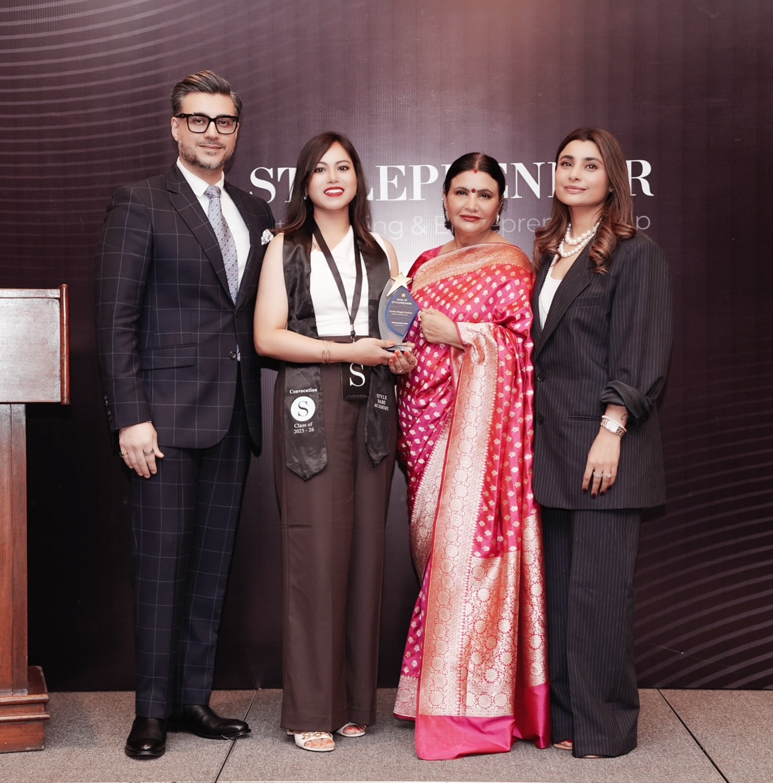Ayona holding a styling recognition award at Style Babe Academy